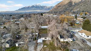 Aerial view of property's location with nearby suburban area and a mountainous background