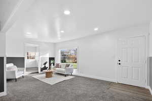 Living area with carpet floors and recessed lighting