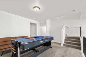Playroom with light carpet and a textured ceiling
