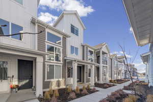 View of front facade featuring board and batten siding, a residential view, and a balcony