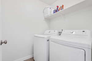 Laundry room with independent washer and dryer and light wood-type flooring