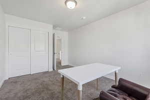 Office area featuring carpet and baseboards