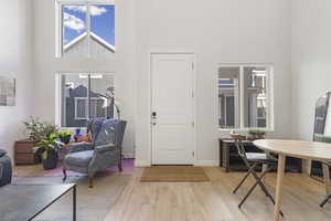 Living area with a high ceiling and wood finished floors