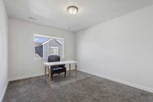 Office area with carpet flooring and baseboards