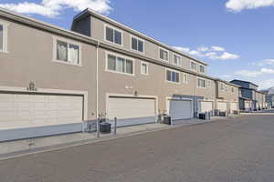 View of property with a residential view and a garage