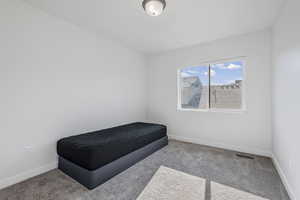 Carpeted bedroom with baseboards