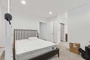 Bedroom featuring light carpet and recessed lighting