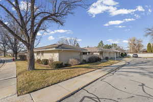 View of front of home with brick siding, driveway, and a garage