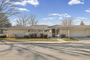 Ranch-style house with brick siding, concrete driveway, and an attached garage