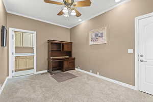 Unfurnished office with light colored carpet, ornamental molding, a ceiling fan, and recessed lighting