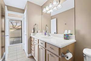 Half bath with vanity and light tile patterned floors