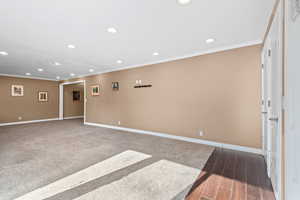 Unfurnished room featuring recessed lighting, ornamental molding, and wood tiled floors