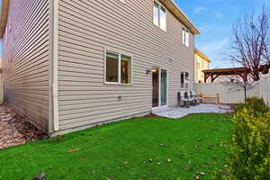 Rear view of house with a patio area, a fenced backyard, and a gazebo