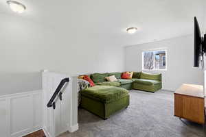 Living area with a wainscoted wall and a decorative wall