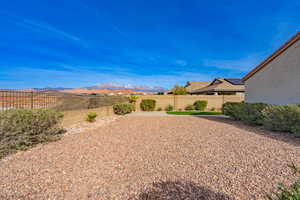 Fenced backyard with a mountain view