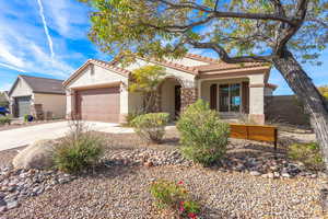 Mediterranean / spanish-style house with driveway, stucco siding, a tiled roof, and a garage