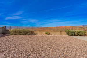 Fenced backyard featuring a mountain view