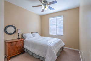 Bedroom with carpet and ceiling fan