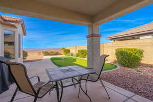 Fenced backyard featuring an area to practice putting, a patio, grilling area, and a mountain view