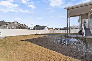 Fenced backyard with a residential view