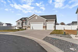 View of front facade with concrete driveway and a garage