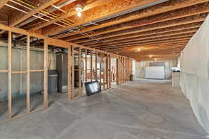 Unfinished basement featuring a water softener