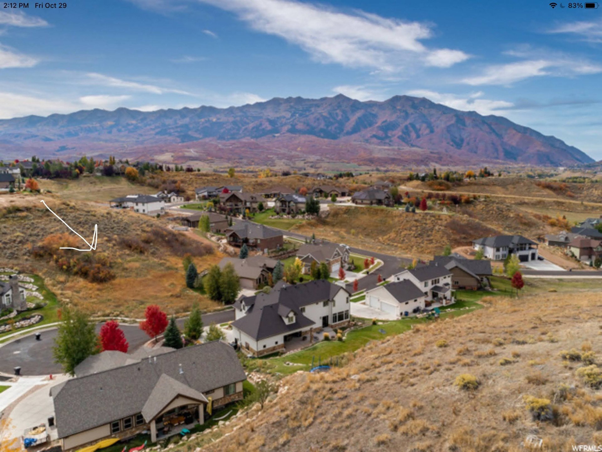 Aerial view of residential area featuring a mountain backdrop