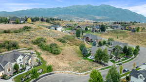 Aerial perspective of suburban area featuring a mountainous background