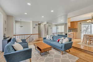 Living area with recessed lighting, light wood-type flooring, and a chandelier