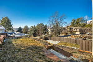 Fenced backyard featuring a residential view