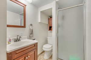 Full bathroom with a stall shower, vanity, and light tile patterned flooring
