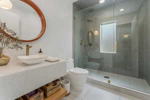 Full bath with vanity, a stall shower, and tile patterned floors