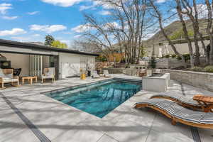 View of pool featuring a patio and an outdoor fire pit
