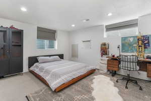 Bedroom with an office area and recessed lighting