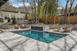 View of pool with a patio and a fenced backyard