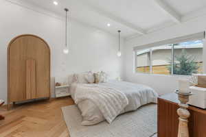 Bedroom featuring beamed ceiling and arched walkways