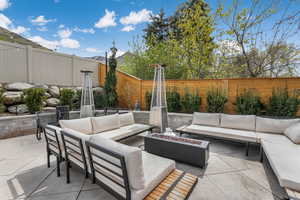 Fenced backyard featuring a patio area and an outdoor living space