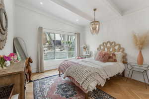 Bedroom with a chandelier and brick wall