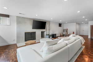 Living room featuring recessed lighting and a tiled fireplace