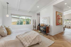 Bedroom with beam ceiling and baseboards