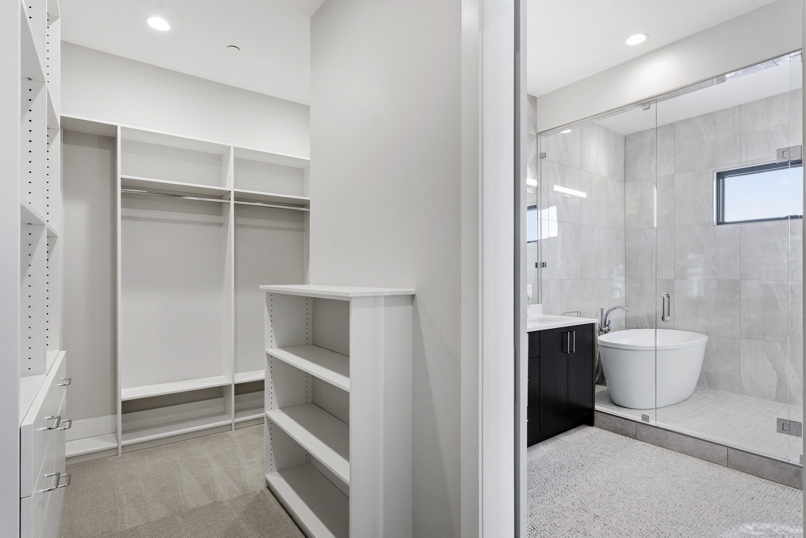 Spacious walk-in closet with extensive built-in shelving, hanging rods, and drawer storage