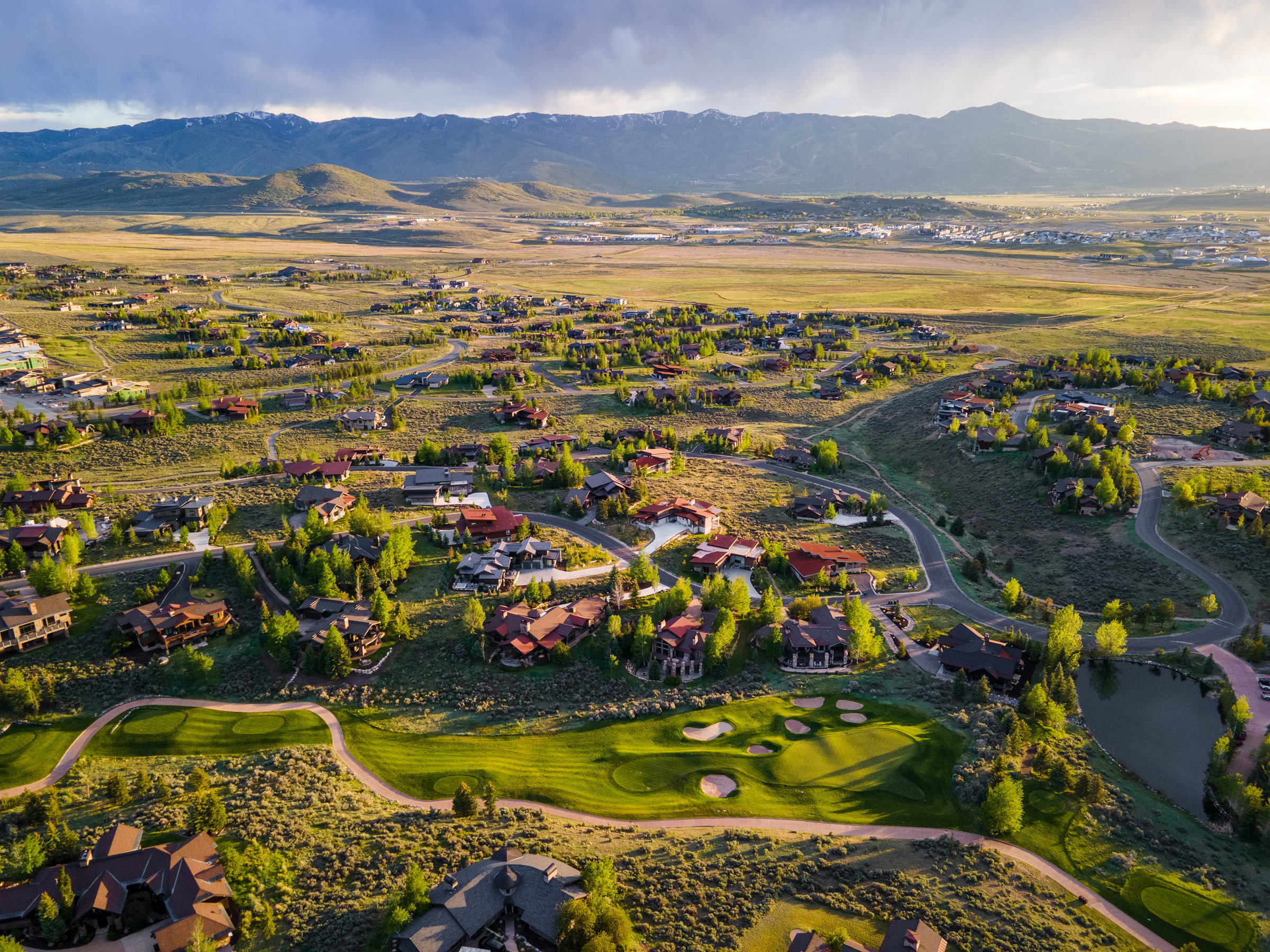 Expansive residential area featuring numerous properties set among rolling hills and natural landscaping