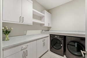 Laundry room with washer and dryer and cabinet space