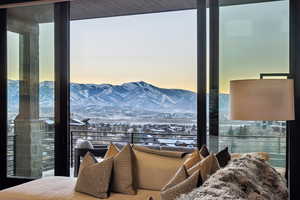 Bedroom featuring a mountain view and expansive windows