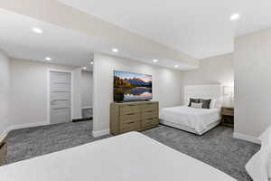 Carpeted bedroom with baseboards and recessed lighting