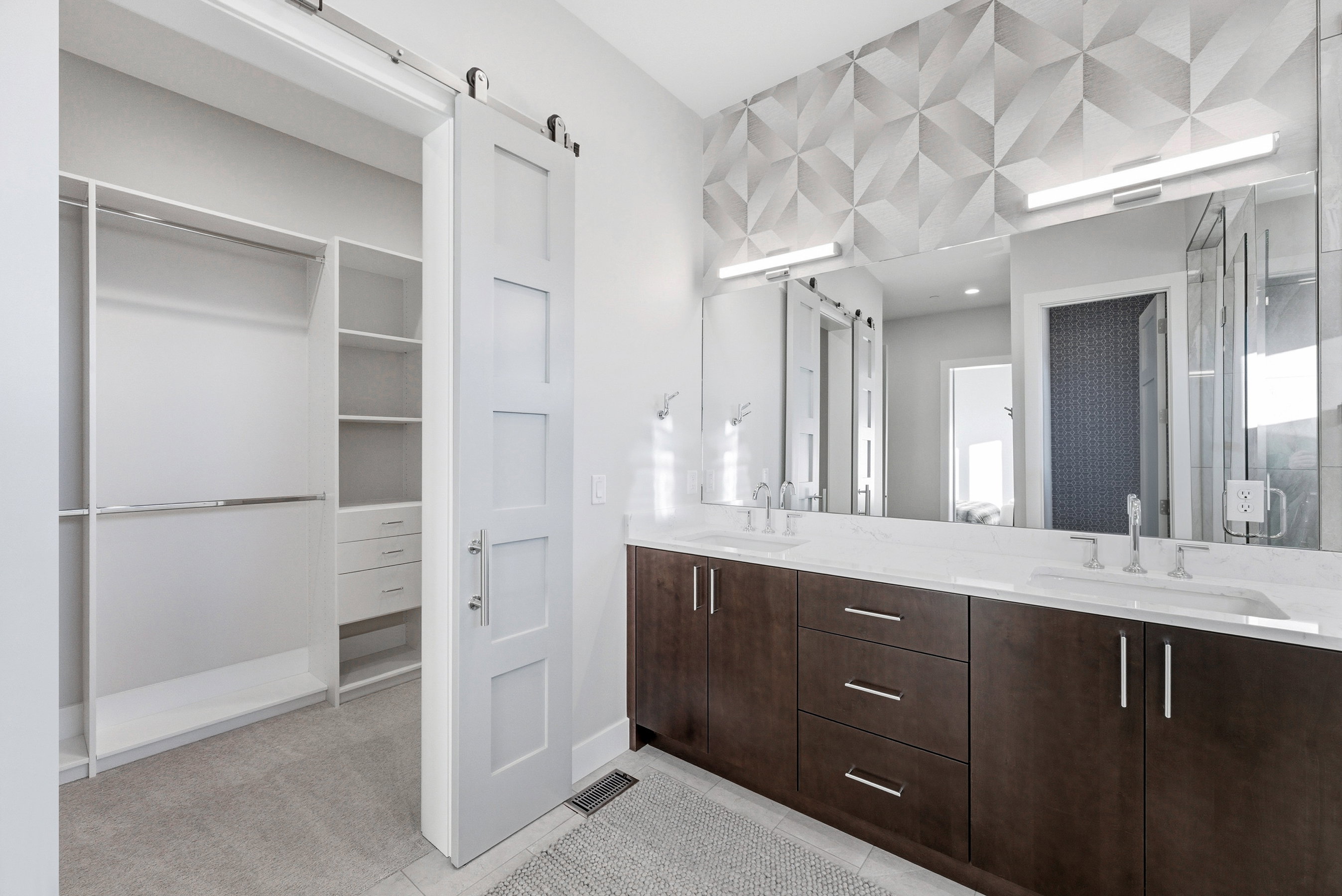 Bathroom featuring a dual vanity with dark wood-finish cabinetry, white countertop, and contemporary rectangular sinks