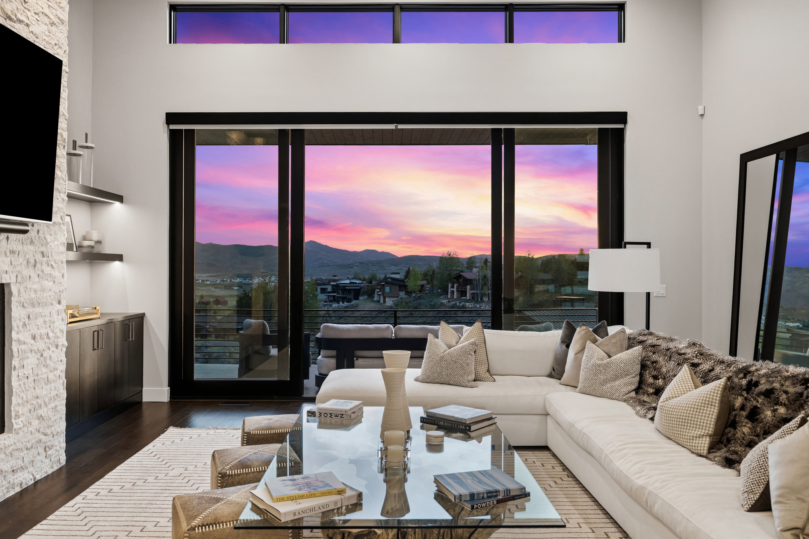 High ceilings complemented by dark-framed floor-to-ceiling sliding glass doors and transom windows