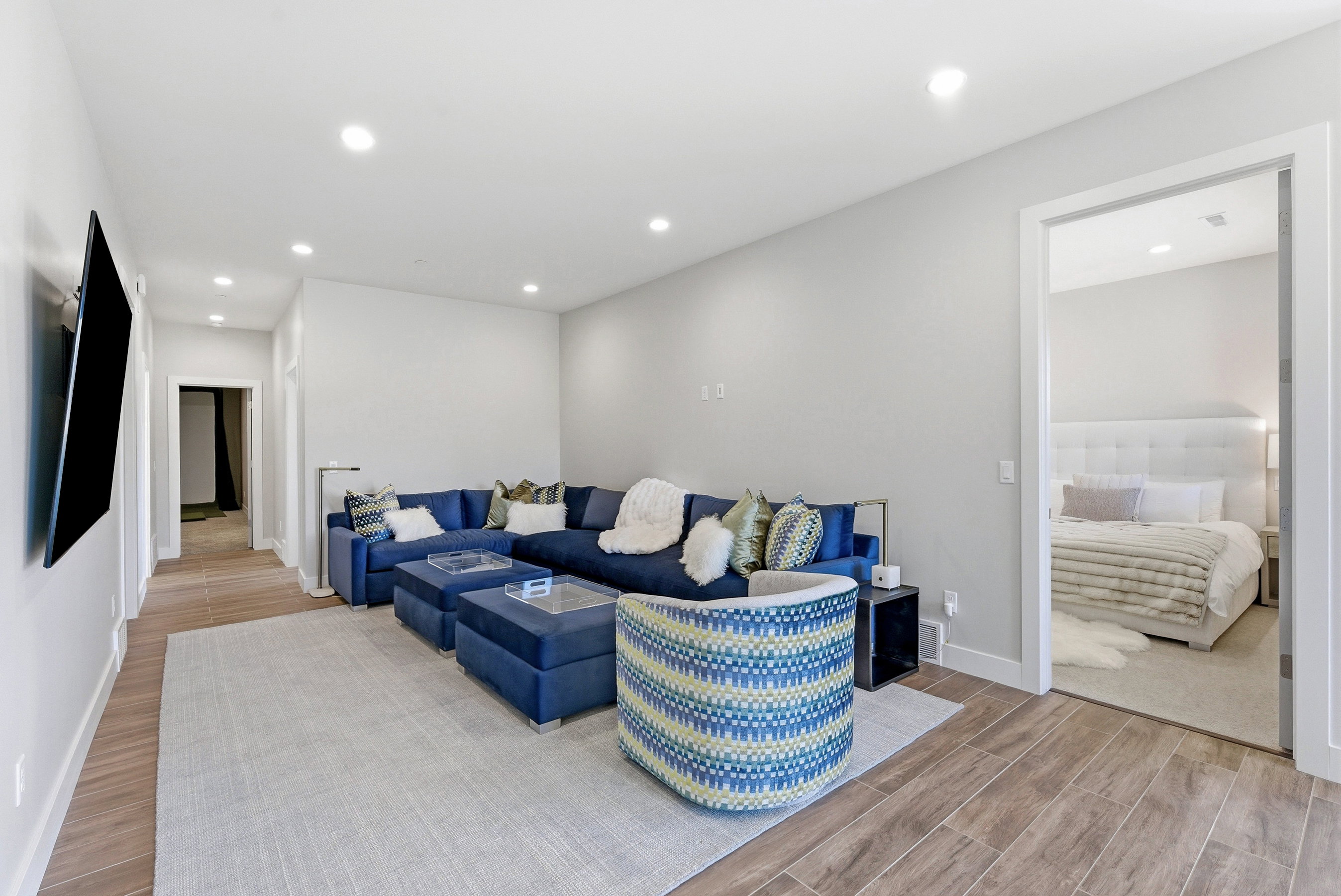 Open concept area with recessed lighting and wood-finish flooring