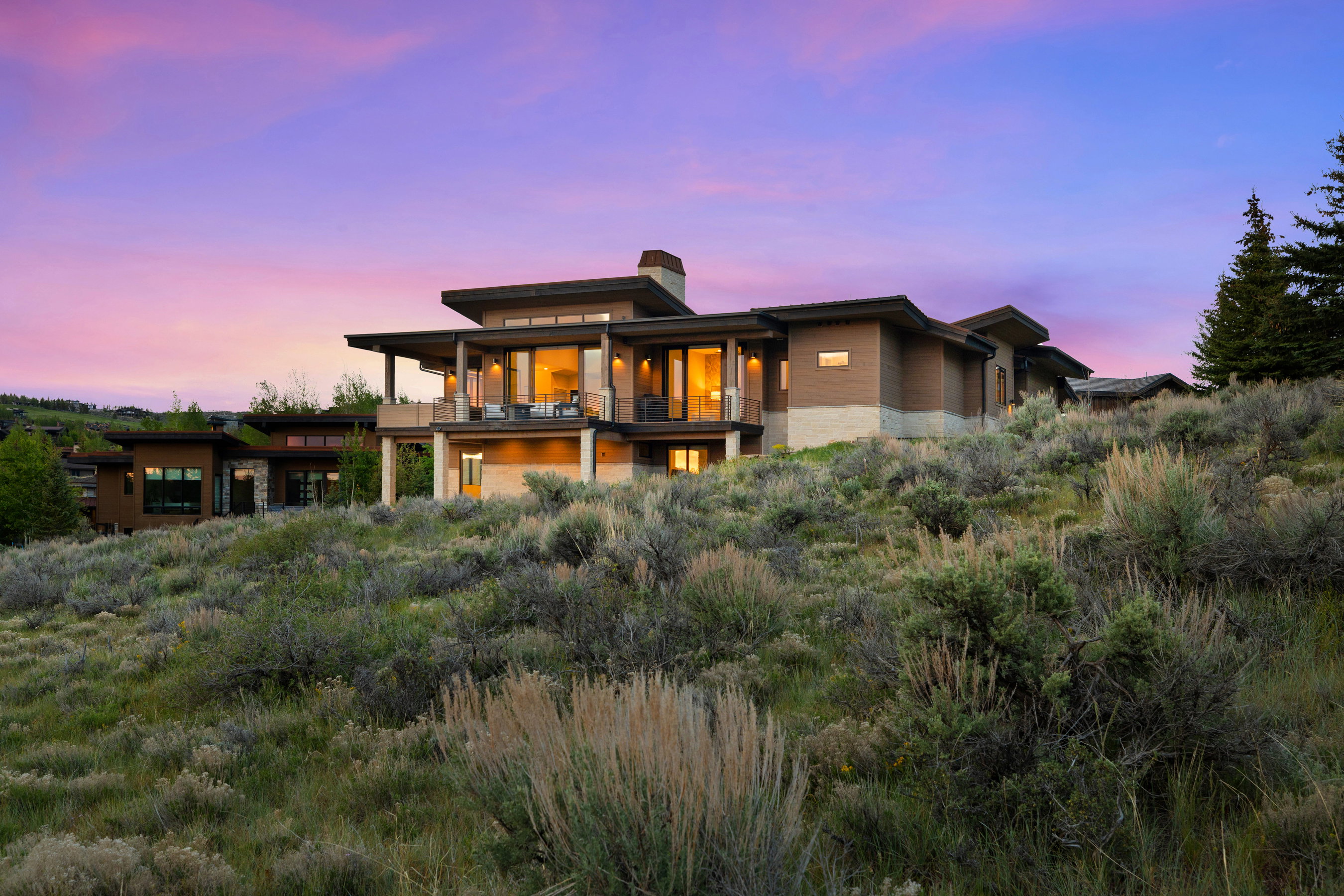 Contemporary residence featuring multiple balconies and expansive windows