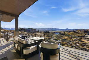 View of patio with a mountain view and a fire pit